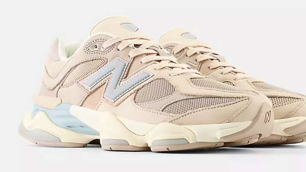 View of tan New Balance shoes.